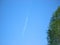 Clear blue sky with two airplanes and parallel contrail line. High sky background with light fluffy trail line from single