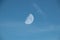 Clear Blue Sky with Whispy Faint Clouds and Faint Half Moon