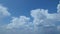 A clear blue sky with white cumulus clouds. An aerial view of the endless scenic skyscape on a bright, sunny day. A