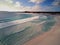 Clear blue water, clouds, beach