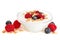 Clear bowl of yogurt with raspberries, blueberries over white