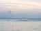 Clear calm sea landscape with nice cloud and sky at sunset twilight. Peace sea in pastel color