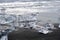 Clear chunks of ice floes wash and break up on the southern shore of an Iceland Beach