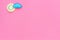 Clear and cloudly weather icons on pink background top view copy space