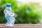 Clear empty plastic bottle on wooden table or counter with green