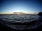 clear evening sky over a calm lake with a lone cloud