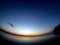 clear evening sky over a calm lake with a lone cloud