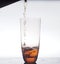 In a clear glass stream poured drink. Photo on a white background.