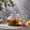 A clear glass teapot filled with blooming tea, unfurling its beautiful petals2