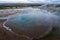 Clear hot pool with big hole towards the ground in the geysir and haukadalur area during blue hour and no people.