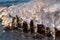 Clear ice icicle close-up sparkling on frozen lake