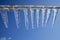 Clear icicles against blue sky