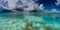 clear marine waters of the Caribbean ocean with white cloudy blue skies and sea landscape
