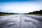 Clear old road/runway and cloudy blue sky