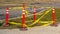 Clear Panorama Traffic poles with caution tape surrounding a hole in the ground near a railway
