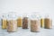 Clear pantry jars with different types of grains in them including quinoa rice buckwheat couscous and barley, simple na