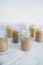 Clear pantry jars with different types of grains in them including quinoa rice buckwheat couscous and barley, simple na