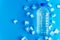 Clear plastic bottle with cold clean drinking water and ice cubes on blue background