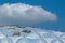 Clear plastic structured modern dome shaped public building detail. blue sky and white clouds