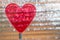 Clear Red Heart On Coil Spring. Metallic Foil Background With Angled Silver Shiny Stripes, Orange Highlights. Valentines Day,