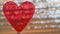Clear Red Heart On Coil Spring. Metallic Foil Background With Angled Silver Shiny Stripes, Orange Highlights. Valentines Day,