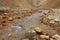 Clear river running among lifeless rocks in Iceland