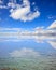 Clear sea surface. Shallow water, blue sky with clouds background