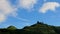 Clear Skies: Mountain Summit\\\'s Serene Blue Sky and Dynamic White Clouds.