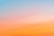 Clear sky with a smooth orange-blue gradient. Sunset