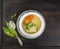 Clear soup with German ravioli,carrots and ramson in silver plate with vintage spoon