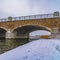 Clear Square Arched bridge and snowy trail the lake in Daybreak