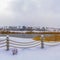 Clear Square Clubhouse overlooking lake and homes against cloudy sky on a frosty winter day