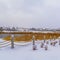 Clear Square Clubhouse overlooking lake and homes against cloudy sky on a frosty winter day