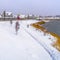 Clear Square Glistening calm lake amid a snow covered landscape during winter in Daybreak