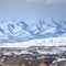 Clear Square Homes with a snowy mountain and cloudy sky background viewed in winter