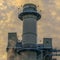 Clear Square Power Plant in Utah Valley against vast sky with puffy clouds at sunset