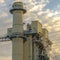 Clear Square Power Plant in Utah Valley emitting smoke against sky filled with puffy clouds