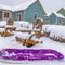 Clear Square Purple sled and wooden chairs surrounded by snow during winter in Daybreak