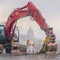 Clear Square Red excavator and barricades on a snowy mountain road in winter