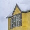 Clear Square Snow falling on a yellow home in Daybreak Utah