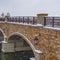 Clear Square Snowy arched bridge over Oquirrh Lake in winter
