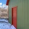 Clear Square Storage shed against trees and snow capped mountain under cloudy blue sky
