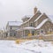 Clear Square Trail impressed on snow covered ground along houses during winter season