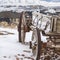 Clear Square Weathered wooden wagon with chains and rusty wheel viewed in winter