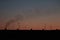 Clear sunrise or sunset sky with a smooth gradient of colors. Dark silhouettes of the roof of the building with antennas and pipes