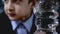 Clear transparent plastic bottle with water close up and a blurred schoolboy sitting by the table, chewing on background