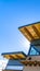 Clear Vertical Building with flat roof and red brick wall under clear blue sky on a sunny day