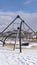 Clear Vertical Climbing frames on a playground blanketed with snow on a sunny winter day