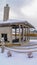 Clear Vertical Clubhouse overlooking lake and homes against cloudy sky on a frosty winter day