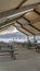 Clear Vertical Covered picnic area and playground at a park blanketed with snow in winter